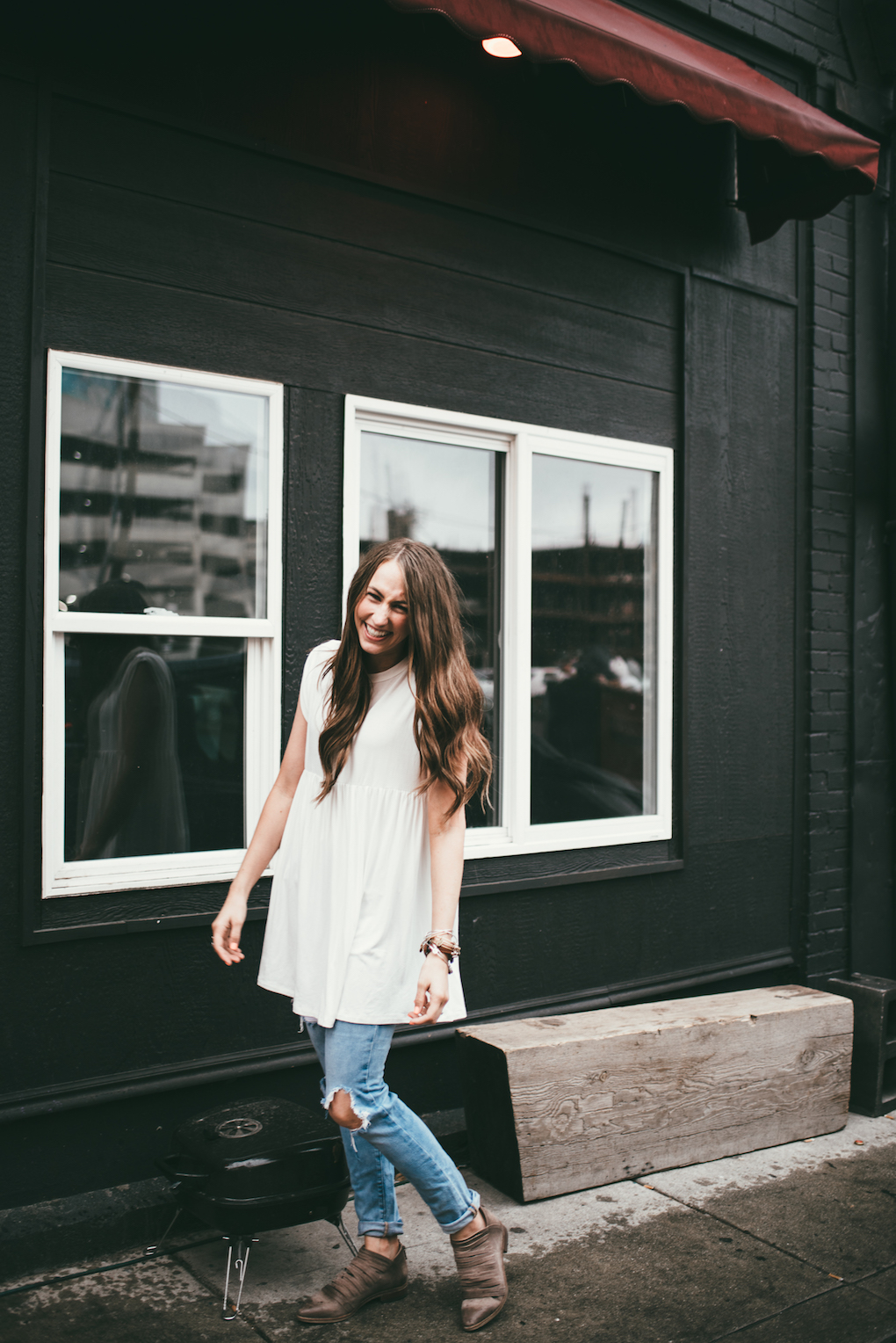 white baby doll tunic paired with distressed denim and free people booties