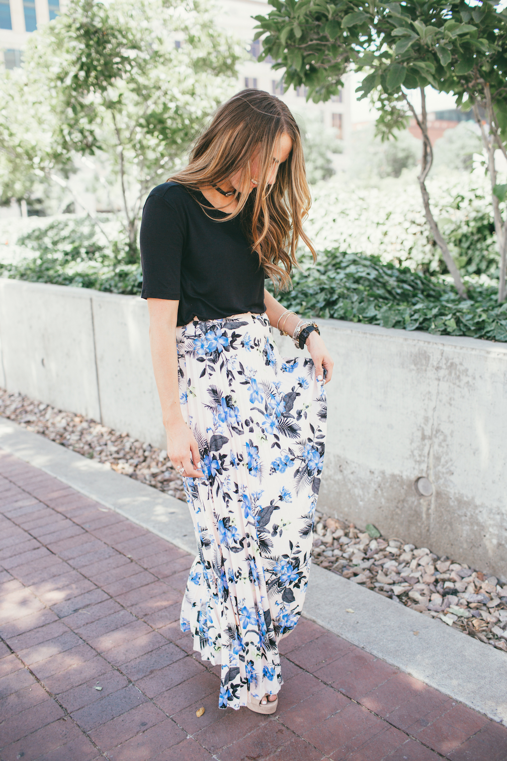 mom in floral pleated skirt with black top