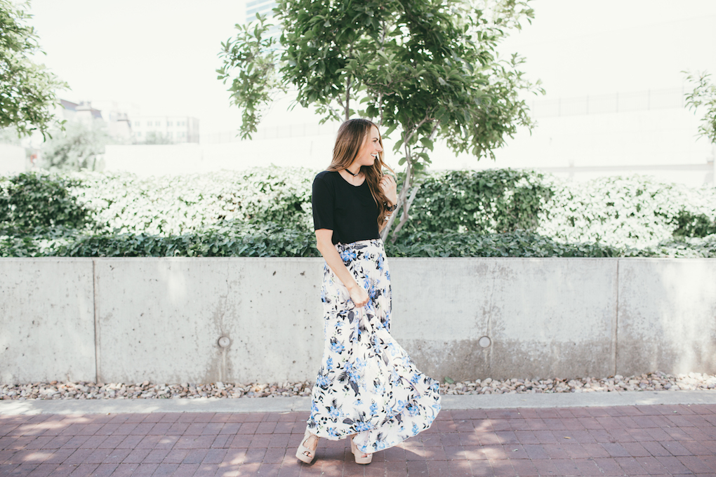mom in floral pleated skirt with black top