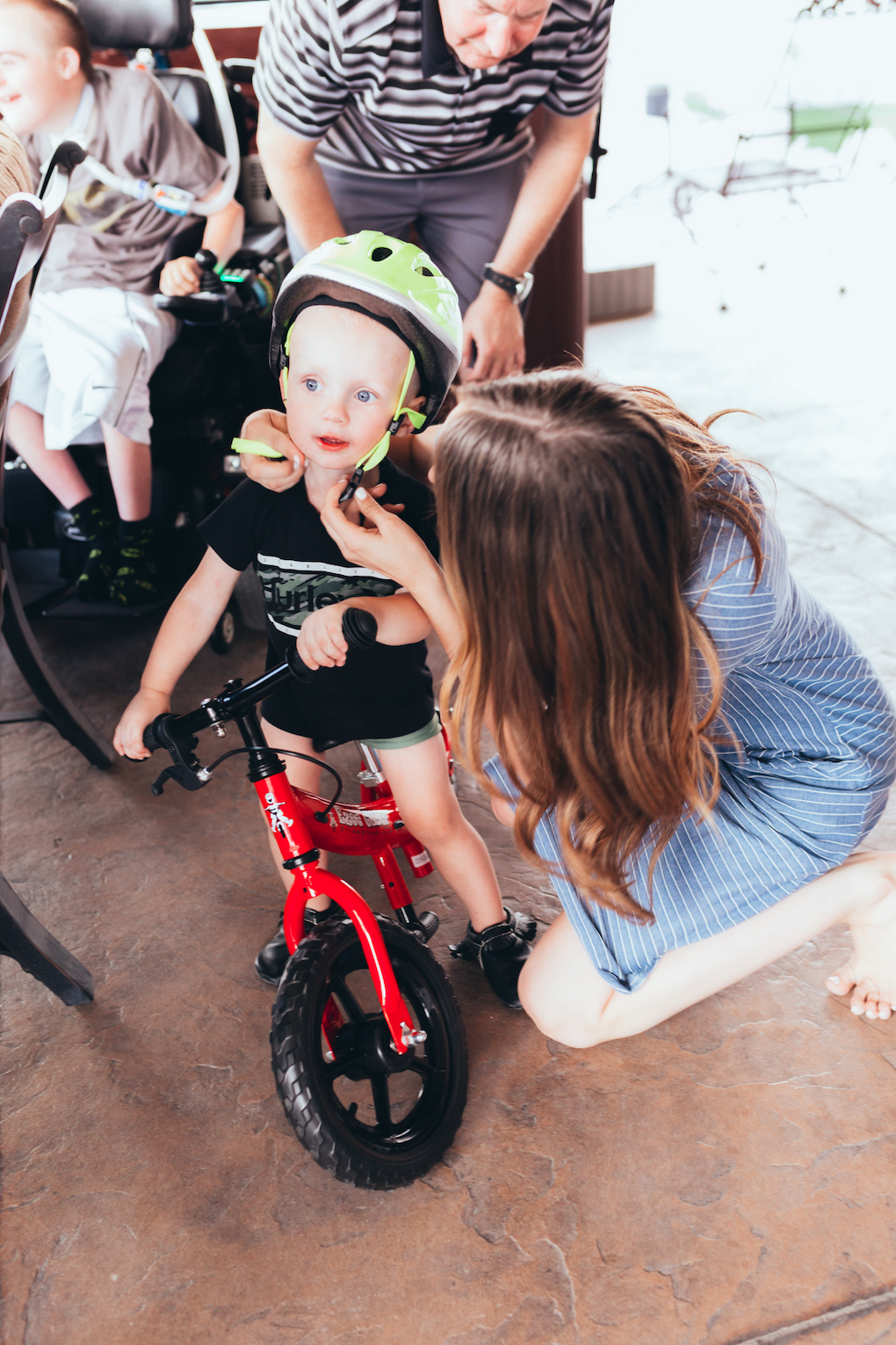KINGS HAPPY UN-BIRTHDAY - KIDS BALL PARTY by Utah blogger Dani Marie - Toddler riding red balance bike with bright green helmet on