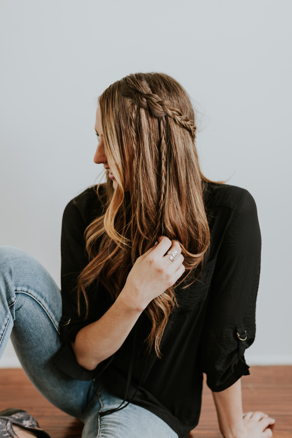girl in black lace up top with braided bohemian hairstyle tutorial