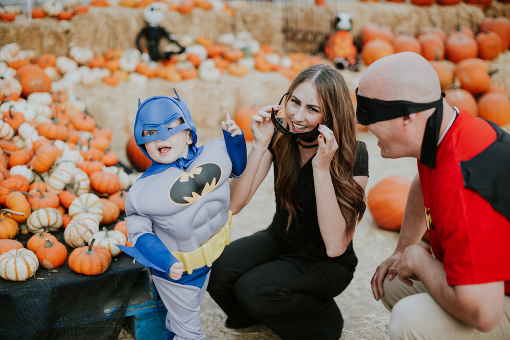 family halloween costume of mom and little boy as batman and batgirl