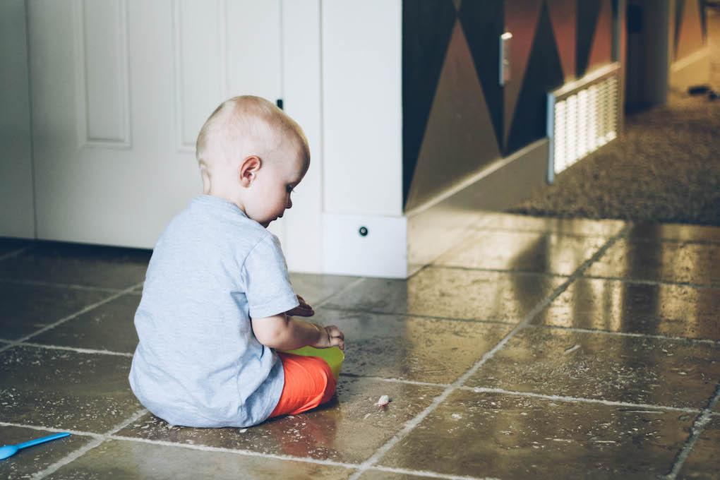 little boy playing on the tile