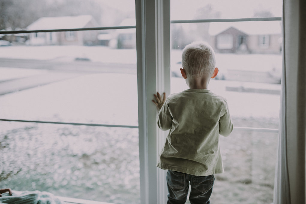 little boy sitting in window wearing june and january
