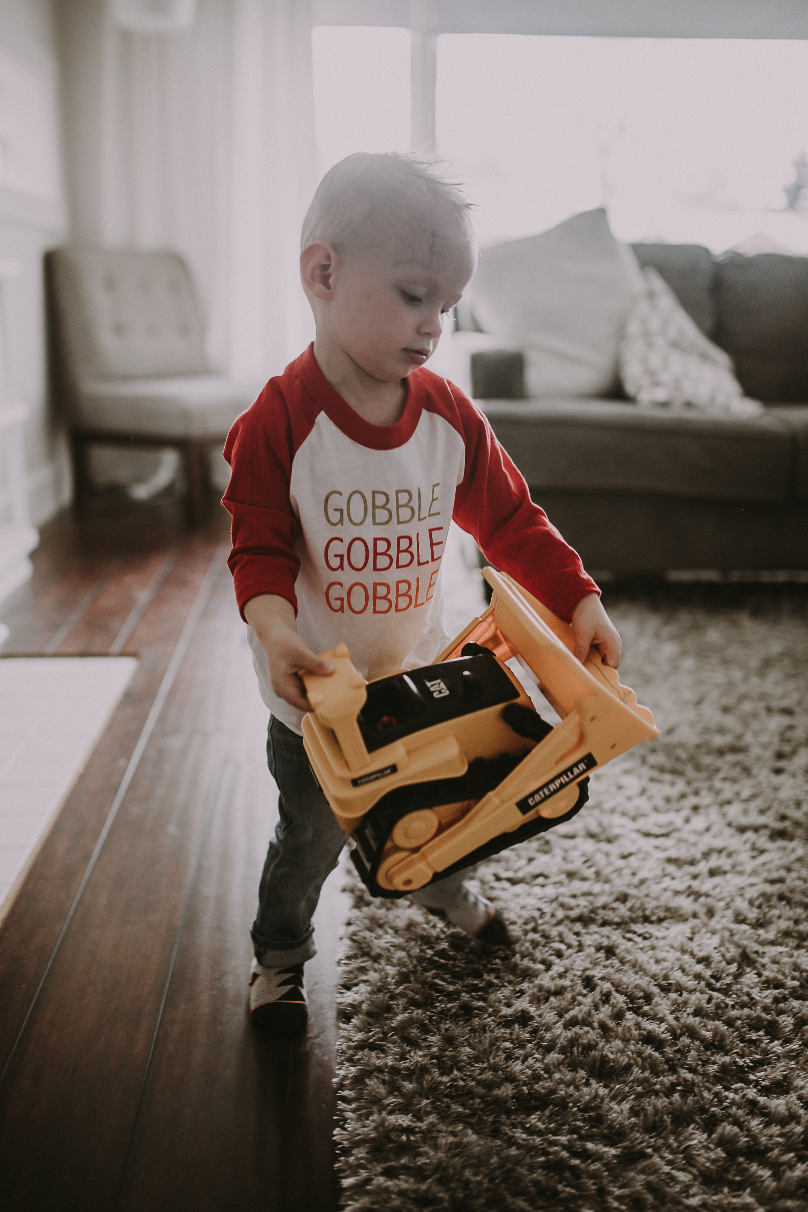 little boy playing wearing gobble tee shirt thanksgiving tee 