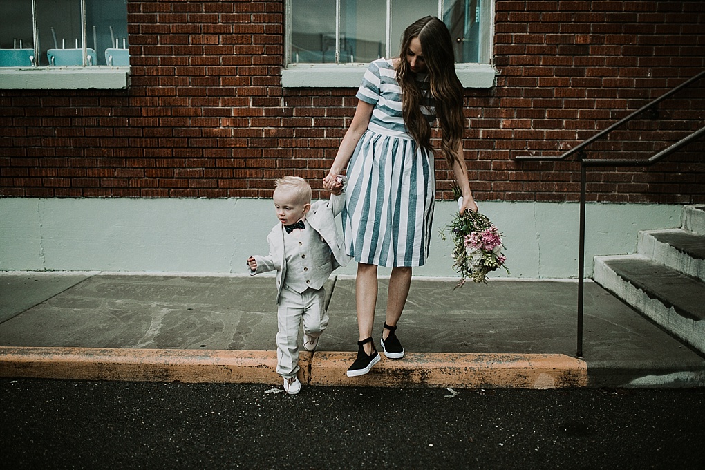 mom and little boy walking little boy in janie and jack linen suit and mom in blue and white stripe shabby apple dress