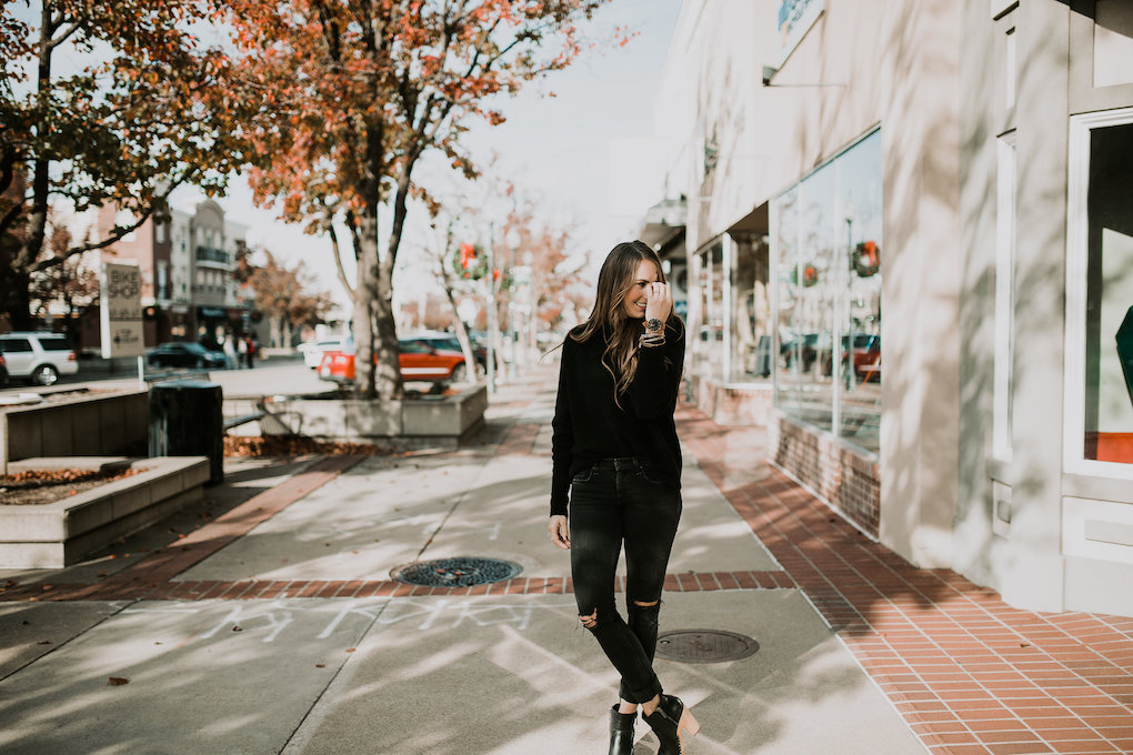 monochromatic black on black look with chunky black turtle neck black jeans and black booties