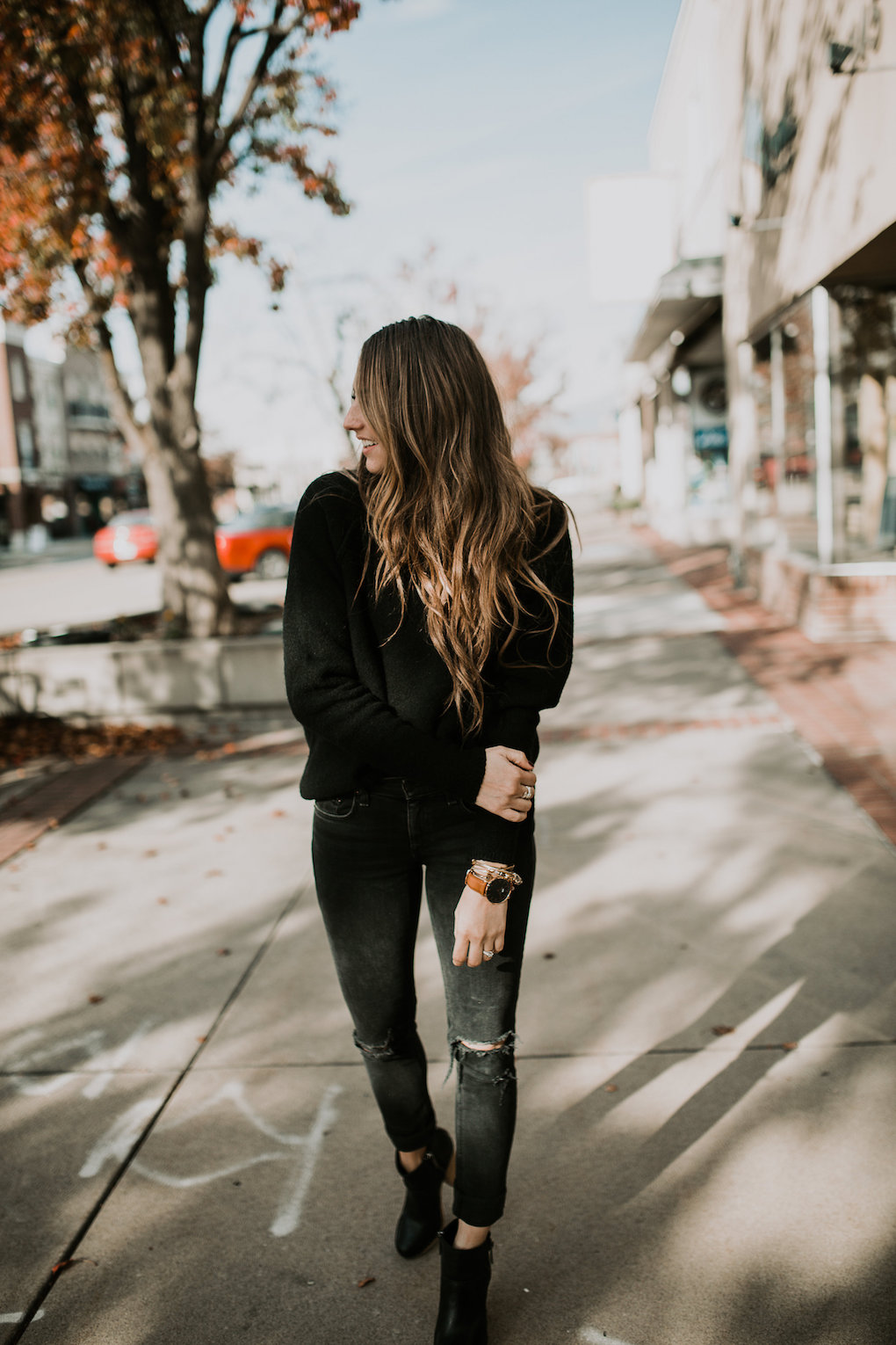 monochromatic black on black look with chunky black turtle neck black jeans and black booties
