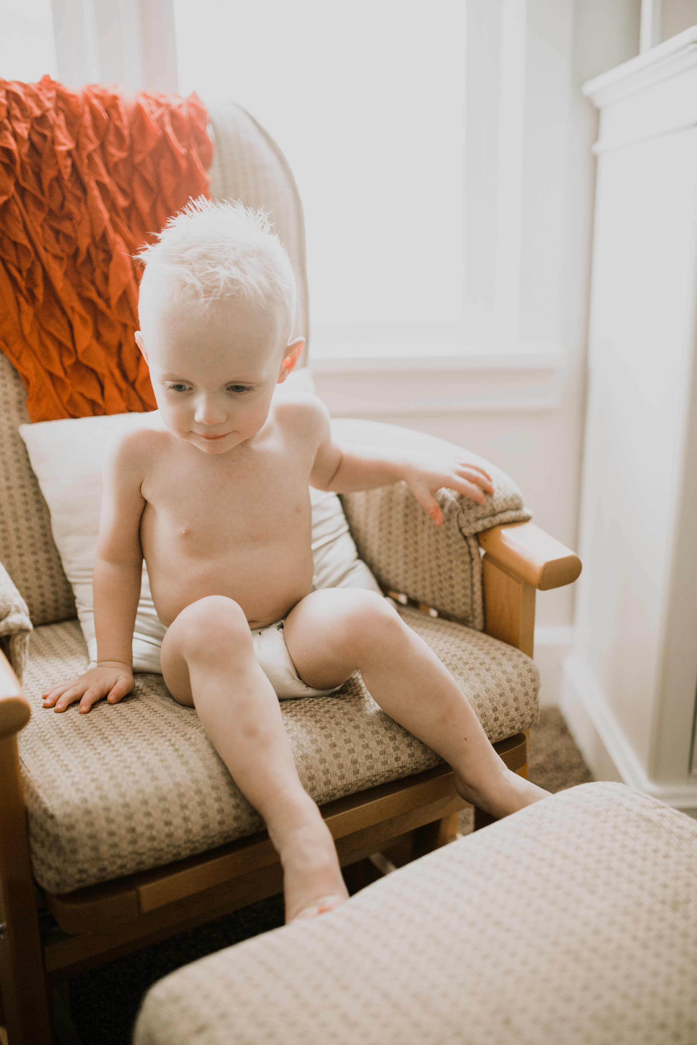 little boy sitting in rocking chair in bambo nature diaper
