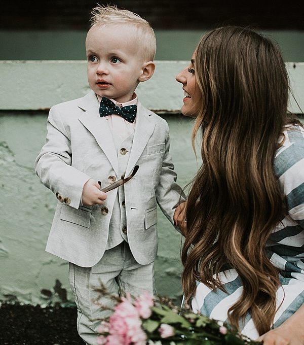 mom and little boy walking little boy in janie and jack linen suit and mom in blue and white stripe shabby apple dress